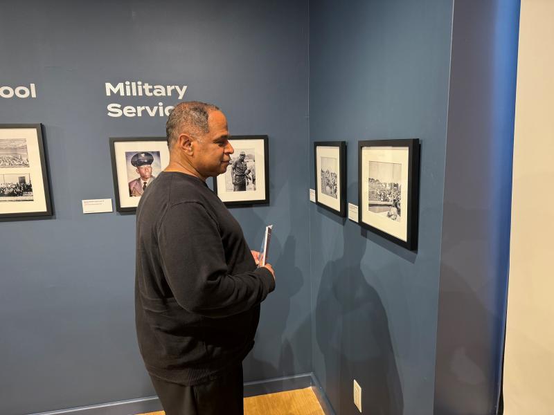 Darnell Daisey looks at photos that show African Americans in military service.